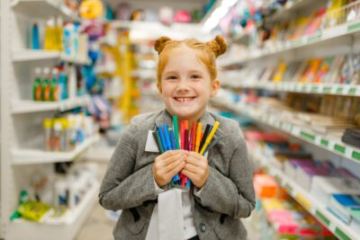 Happy girl with bright markers - school supplies