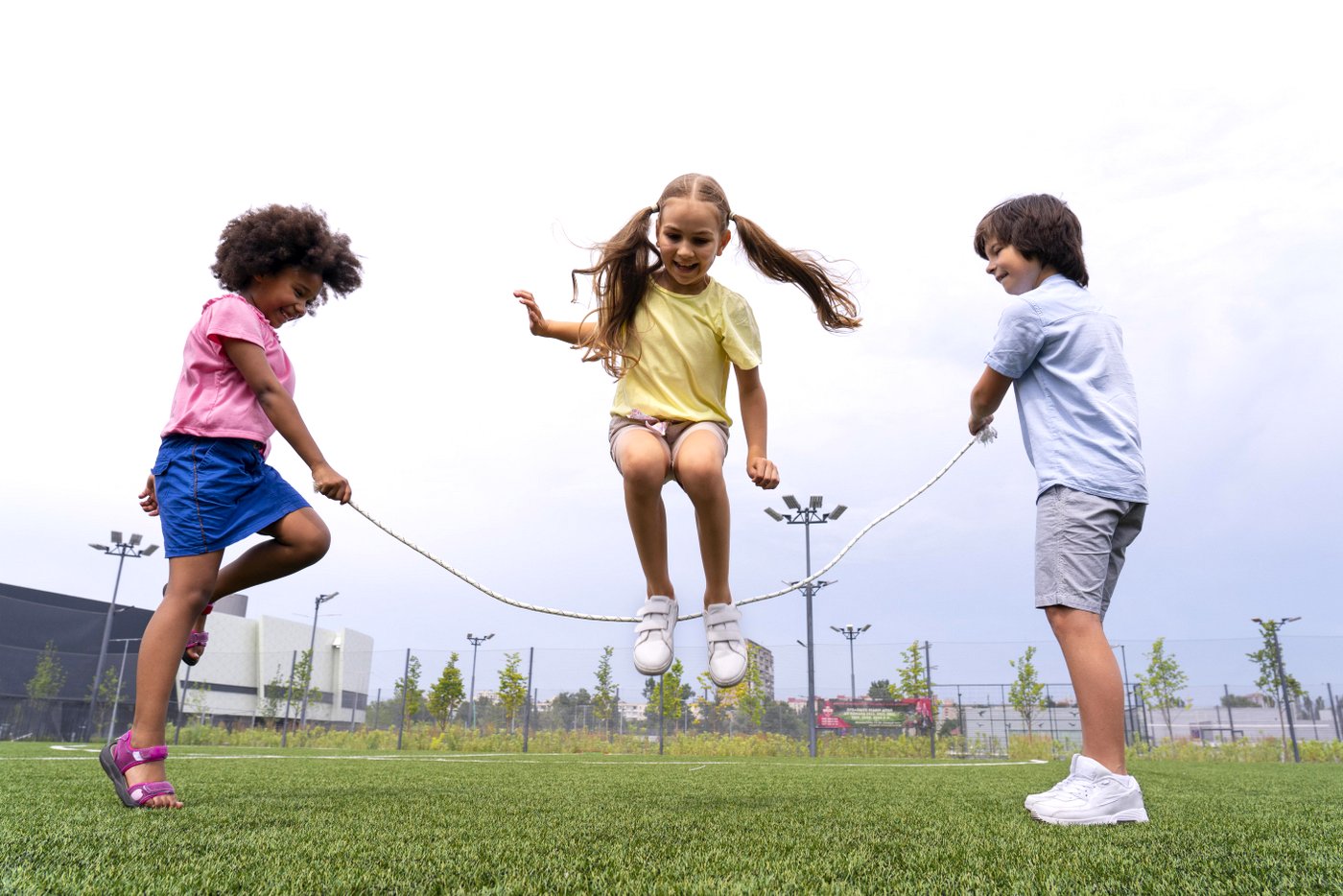 Kids outside playing jump rope