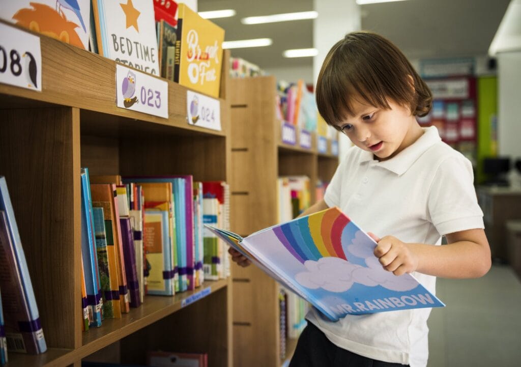 Young boy looking at books in a library